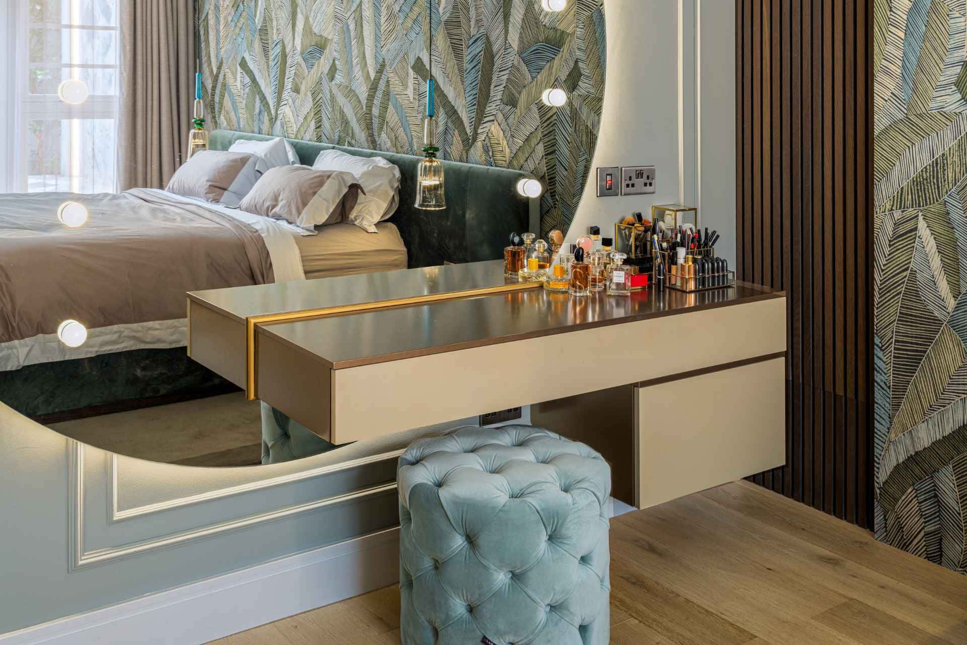 Luxurious vanity table in a bedroom with leaf-patterned wallpaper