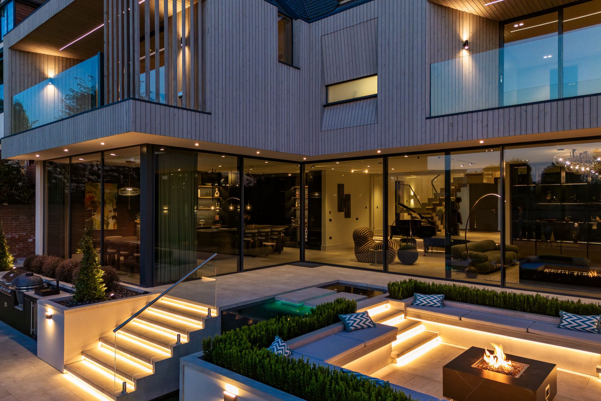 Outdoor living space with modern furniture and lighting in a stylish setting.