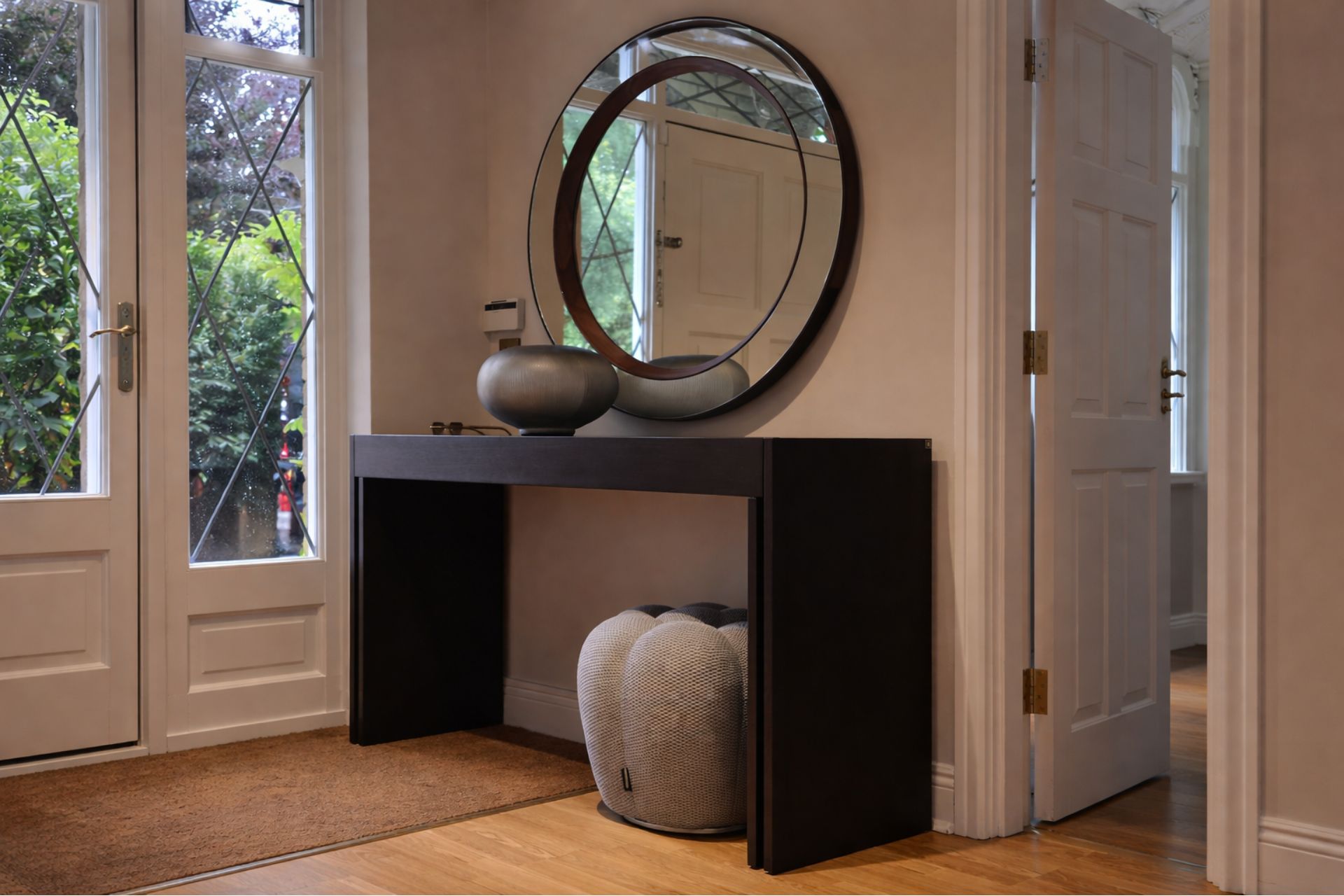 Elegant entryway with modern console table, mirror, and stylish decor accents.